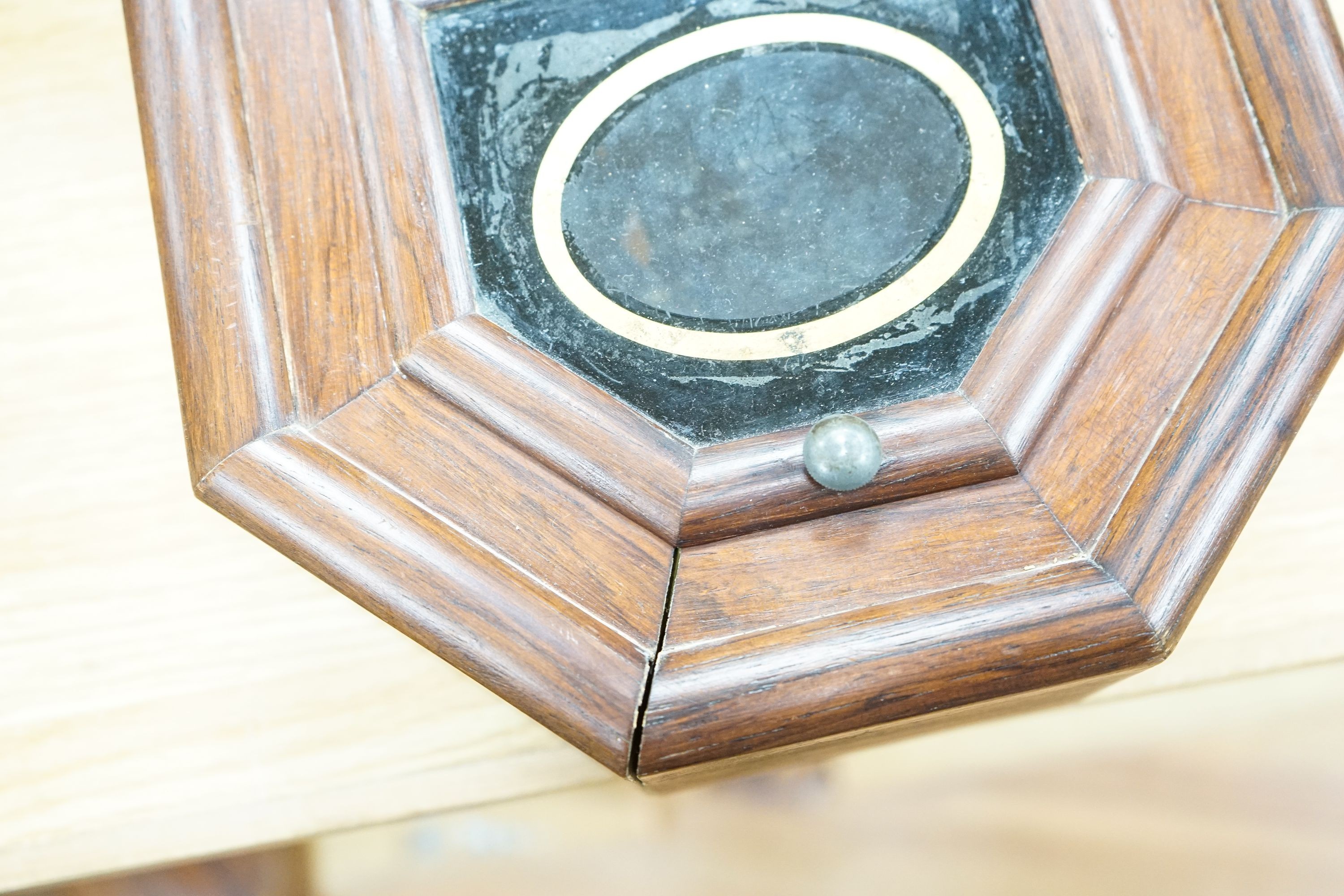 A mahogany octagonal dial clock with key and pendulum 60cm